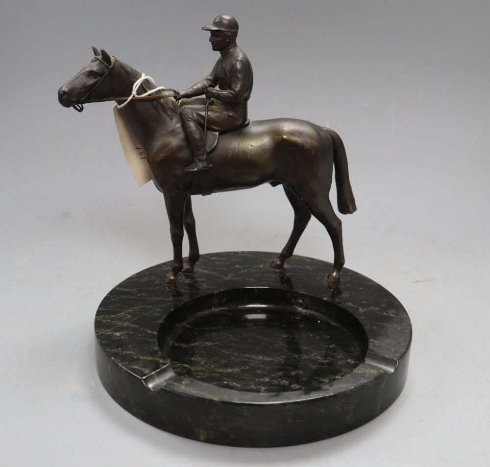 A spelter model of a horse and jockey, surmounted on a serpentine ashtray, height 23cm
